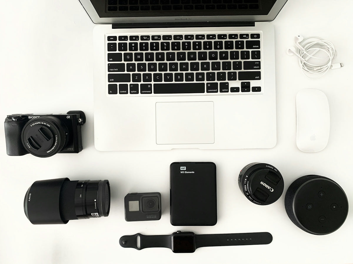 black camera lens beside macbook pro