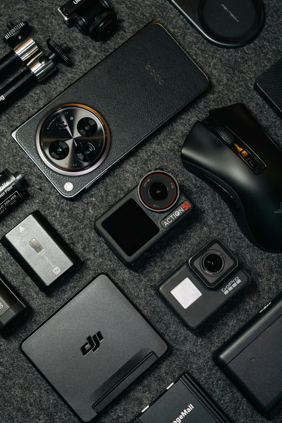 Tech gadgets and accessories arranged on a dark background.