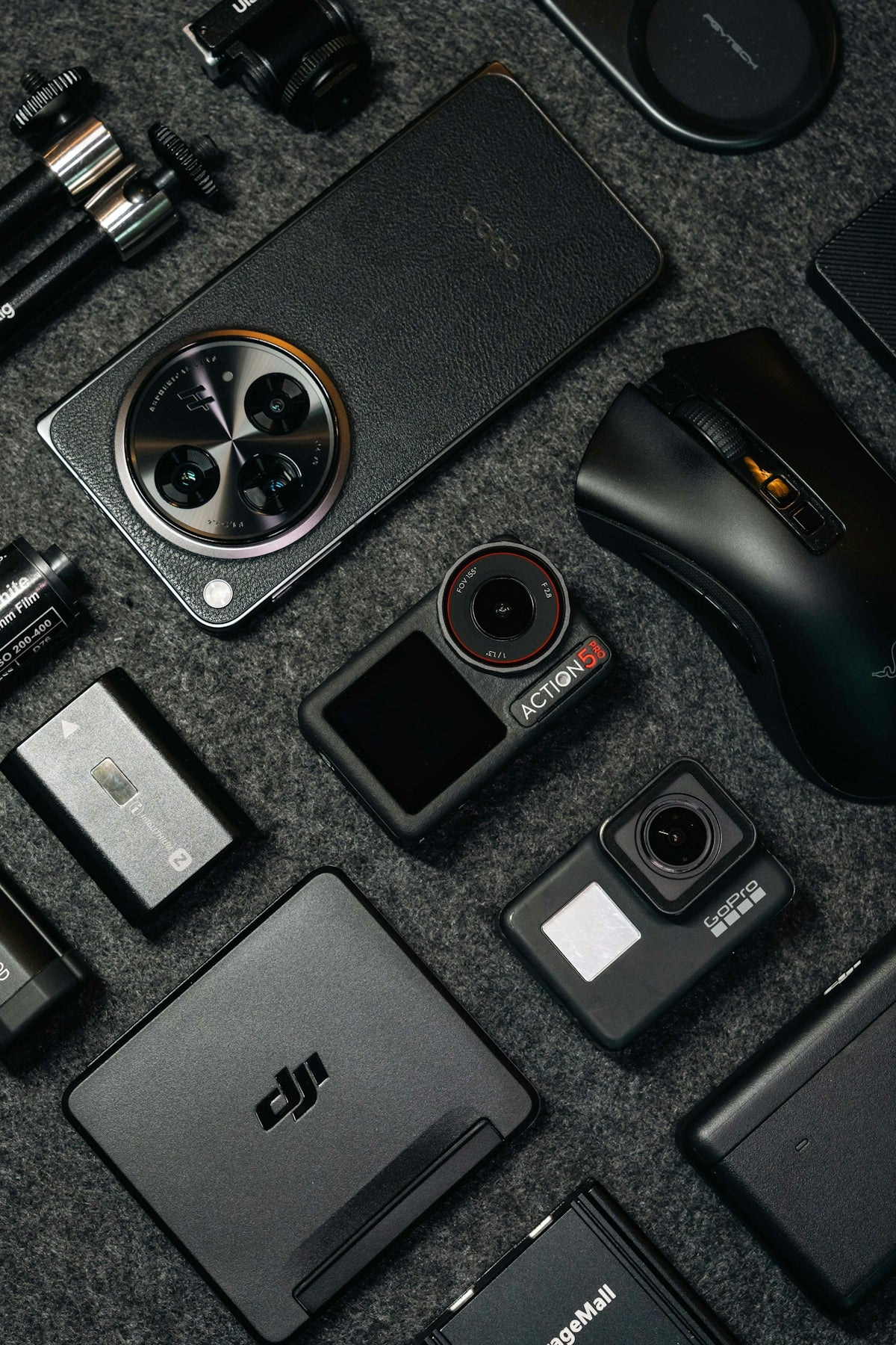 Tech gadgets and accessories arranged on a dark background.